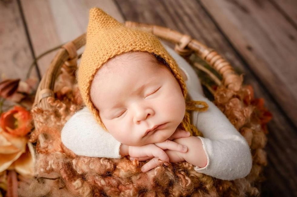 sleeping baby in a bonnet