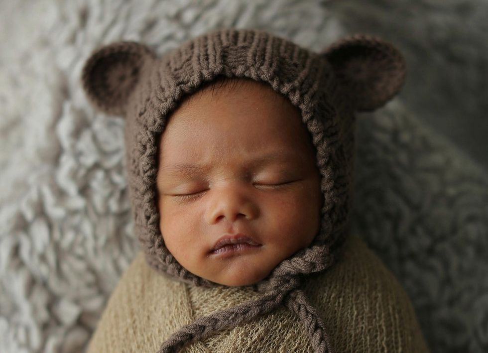 sleeping baby in a bonnet