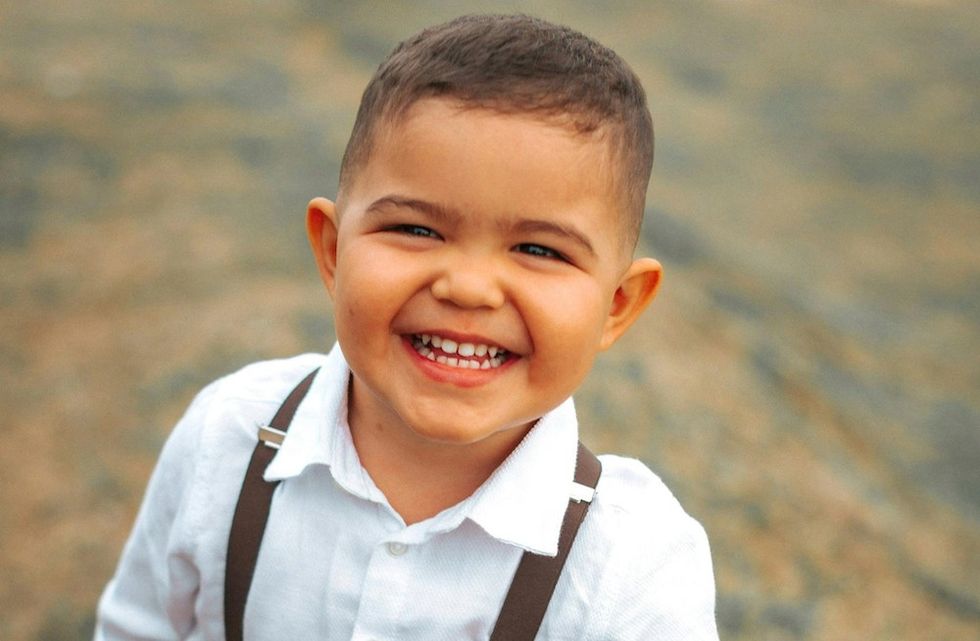 smiling baby in suspenders