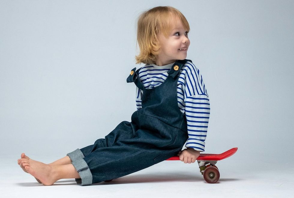 smiling little boy on a red skateboard