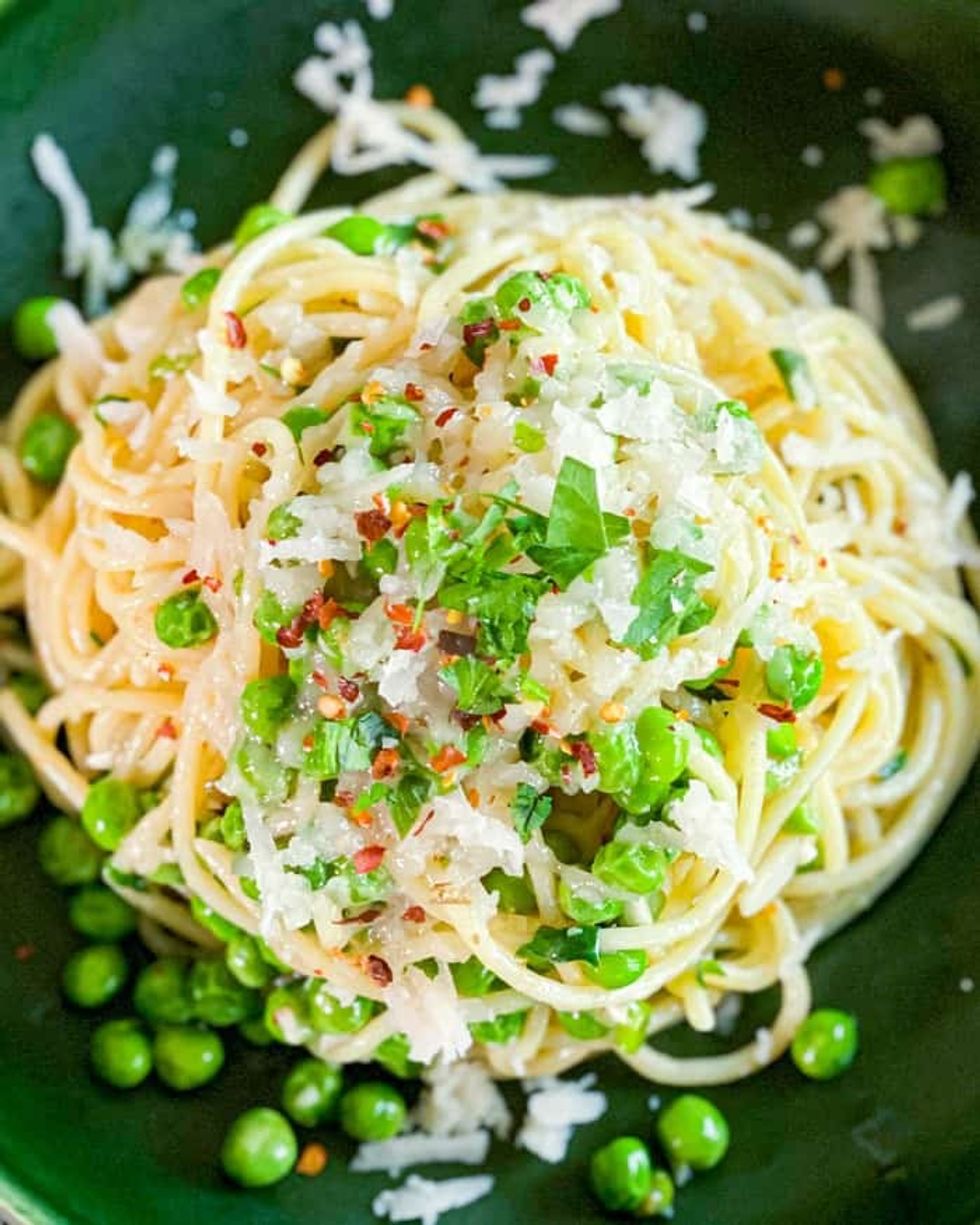 Spaghetti Aglio e Olio is garnished with greenery.