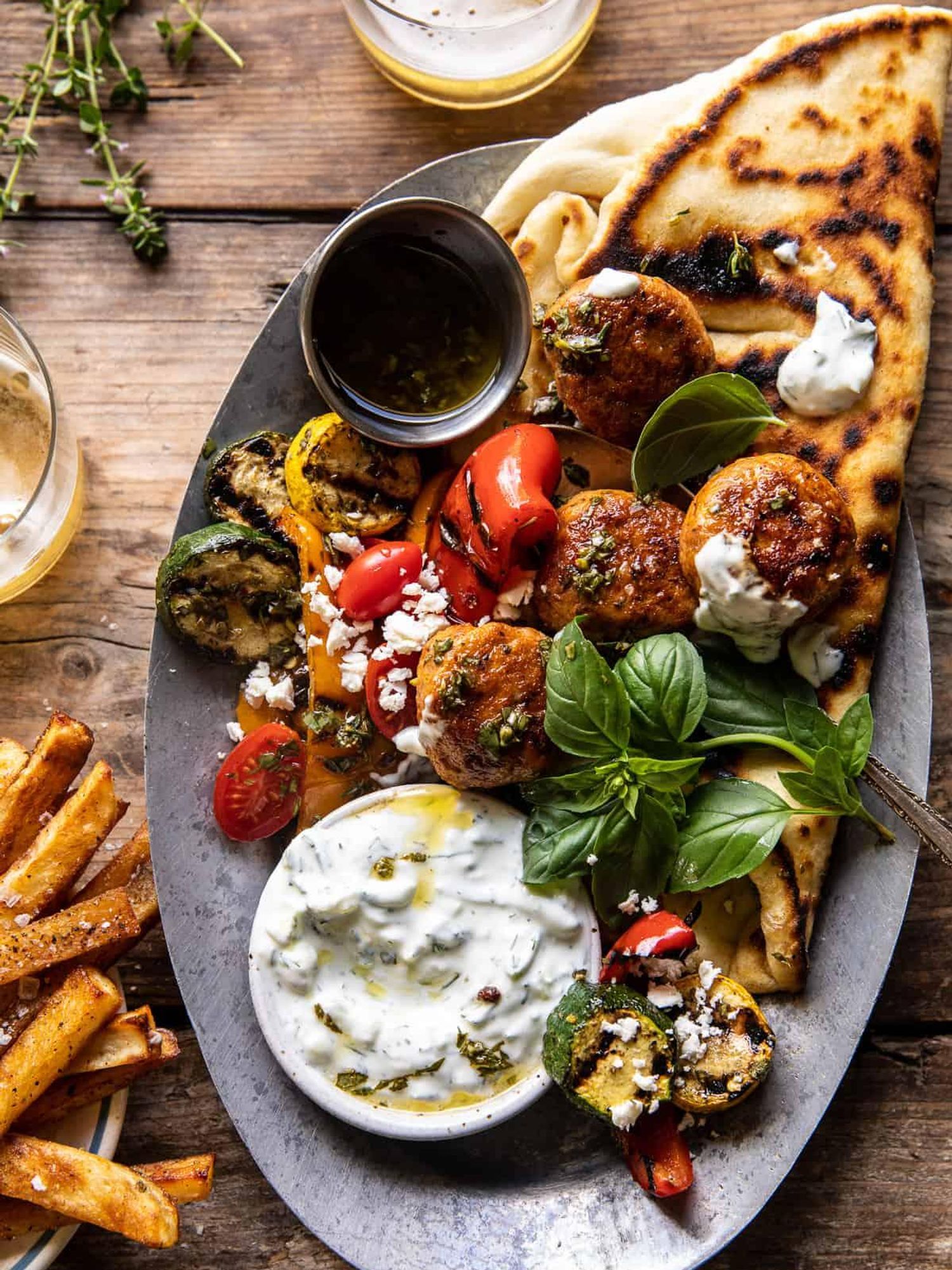 Spicy Oregano Meatballs with Grilled Vegetables and Tzatziki