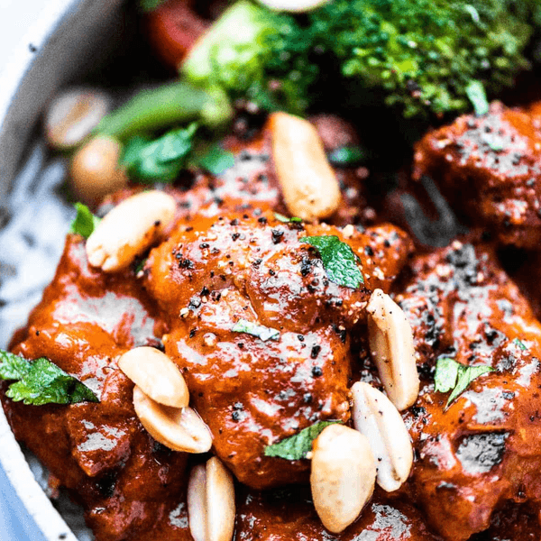 Spicy peanut chicken with broccoli and almonds on a bed of rice.