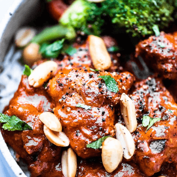 Spicy peanut chicken with broccoli and almonds on a bed of rice.