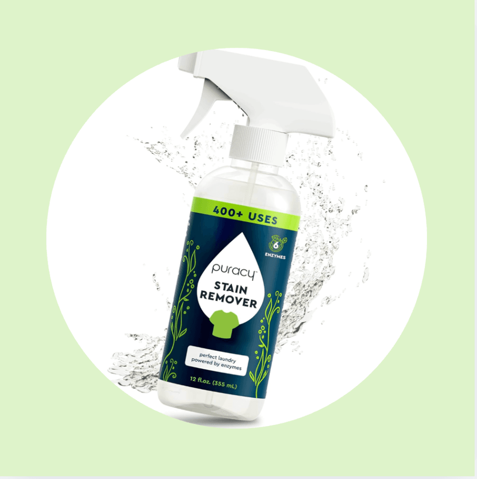 Spray bottle of Puracy stain remover with water splash background.