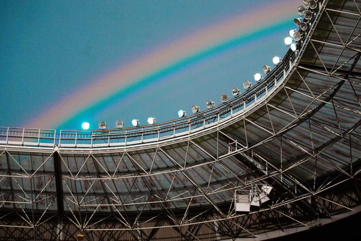 stadium dome and a rainbow across the sky