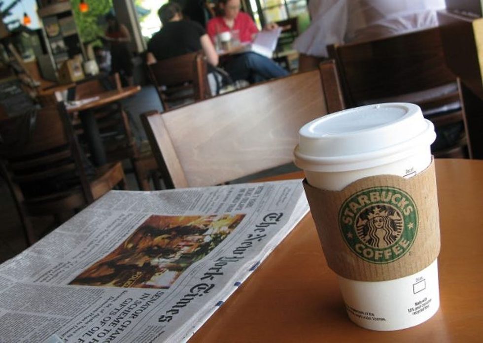 Starbucks cup and newspaper
