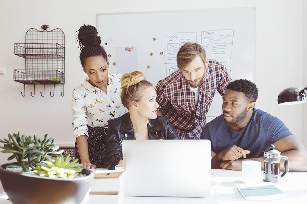 Startup-agency,-multi-ethnic-team-brainstorming,-using-laptop-000074112003_Large