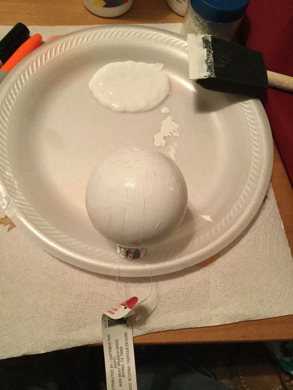 Stick you top of your ornament into your plate to let the first later dry