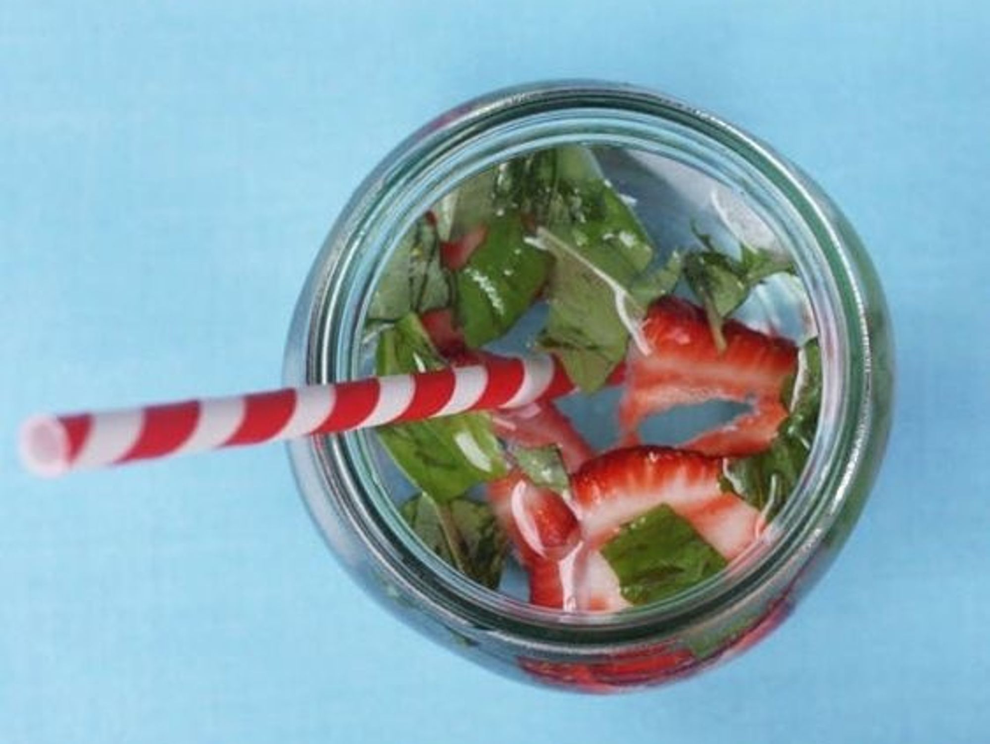 strawberry infused water on a blue background