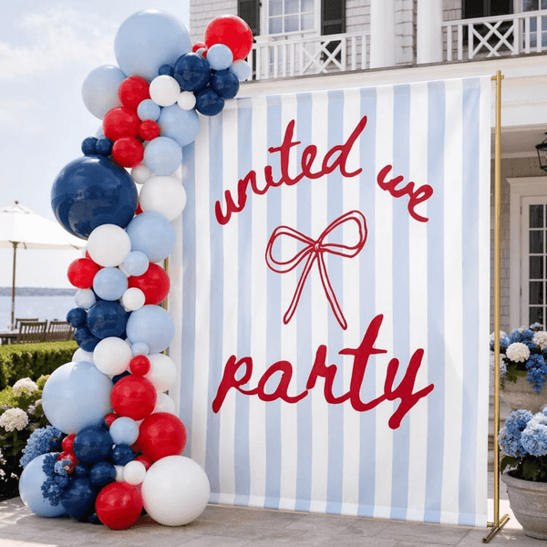 Striped banner with "united we party" and red, white, blue balloons outdoors.