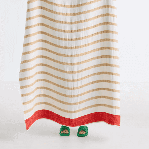 Striped curtain and green sandals with red toenails peeking from underneath.