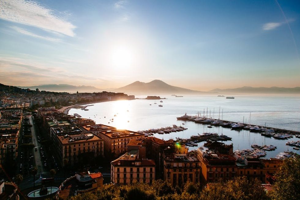 Sunrise on Naples seen from Sant'Antonio balcony, the gulf and the vesuvius are visible, reflection on water.