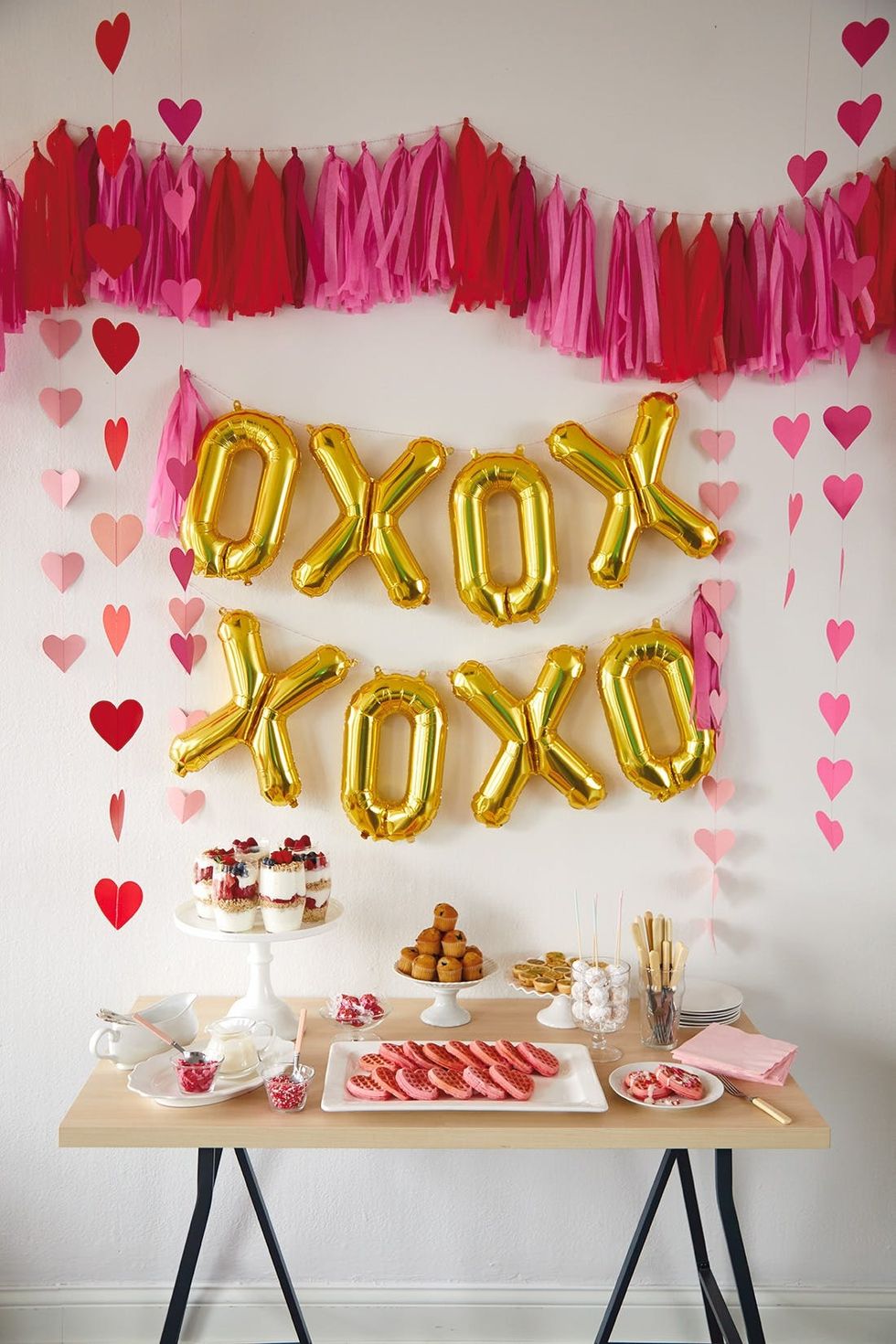 table spread for galentine's brunch under gold balloons