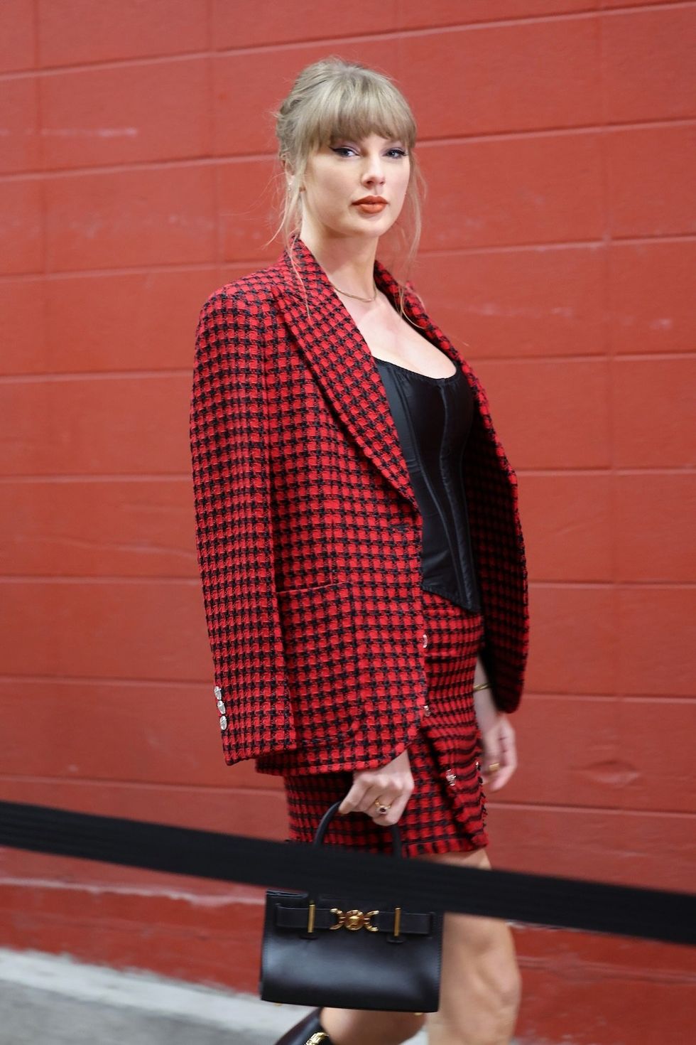 taylor swift wearing a red and black plaid outfit