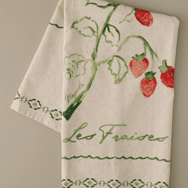 Tea towel with painted strawberries and "Les Fraises" text in green.