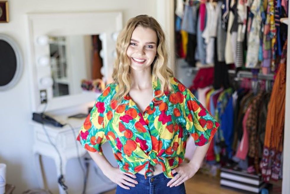 teenage girl posing in front of bedroom closet
