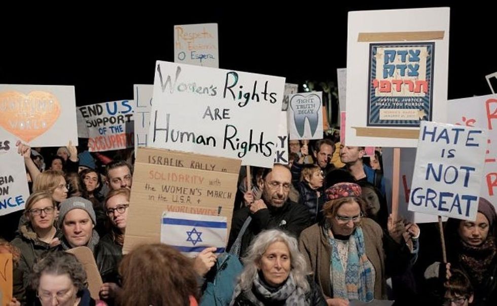 TEL AVIV, ISRAEL - JANUARY 21: Demonstrators hold banners and shout slogans during the protest in support of 'Women's March' parade against President Donald Trump at Washington, outside the US embassy in Tel Aviv, Israel on January 21, 2017. (Photo by Tomer Neuberg/Anadolu Agency/Getty Images)