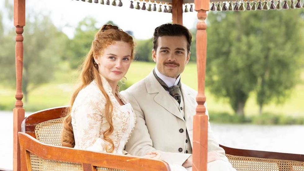 the forsytes sitting in a chair together beside a lake