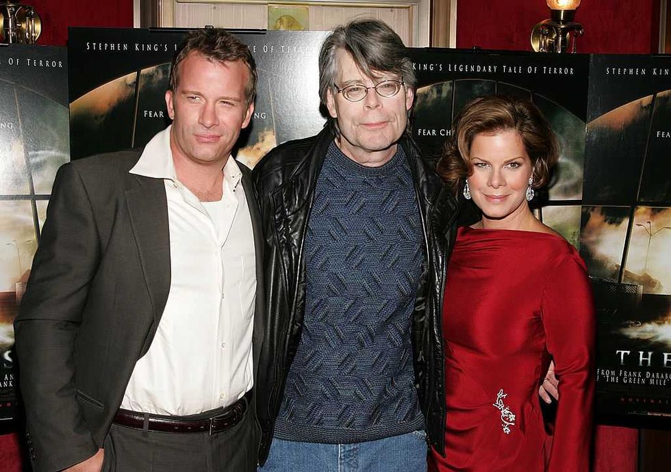 The Mist Stephen King cast at an event, with posters in the background.