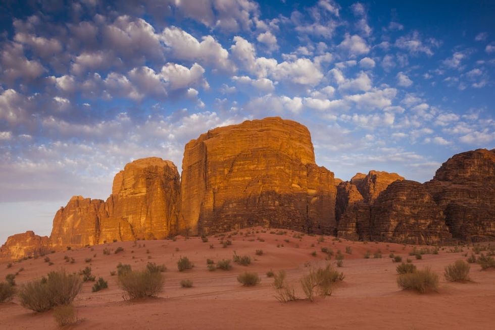The morning sun strikes a rock formation in Wadi Rum