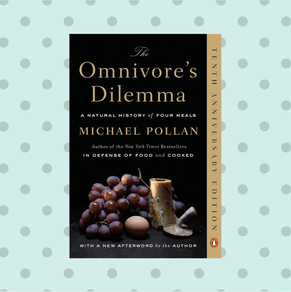 "The Omnivore\u2019s Dilemma" book cover, grapes and corncob on a dotted background.