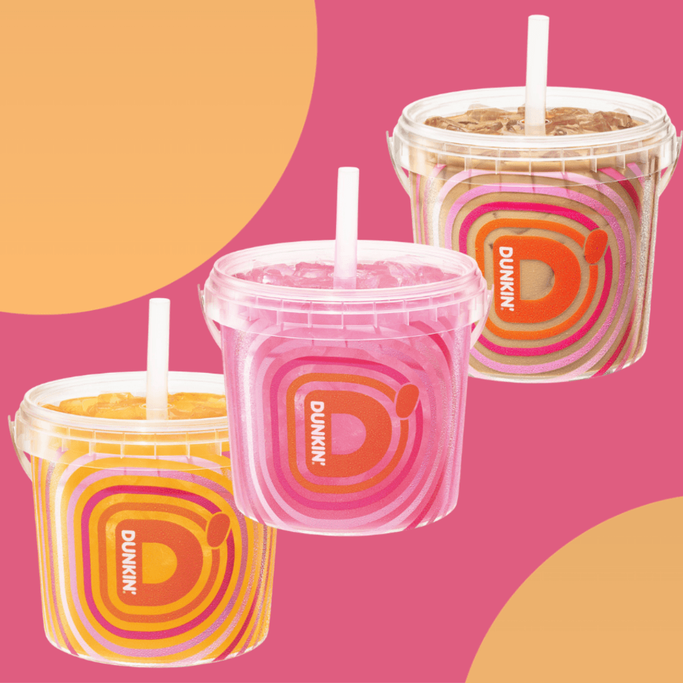 Three colorful Dunkin' drinks in vibrant, branded containers with straws.