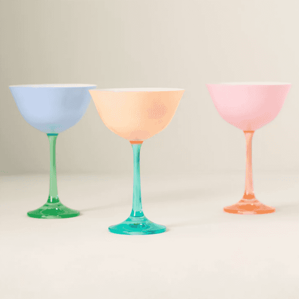 Three colorful martini glasses with pastel tones on a neutral background.