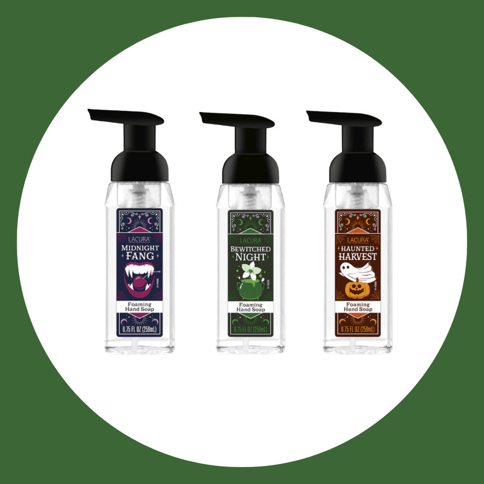 Three Halloween-themed foaming hand soap bottles on a white and green background.