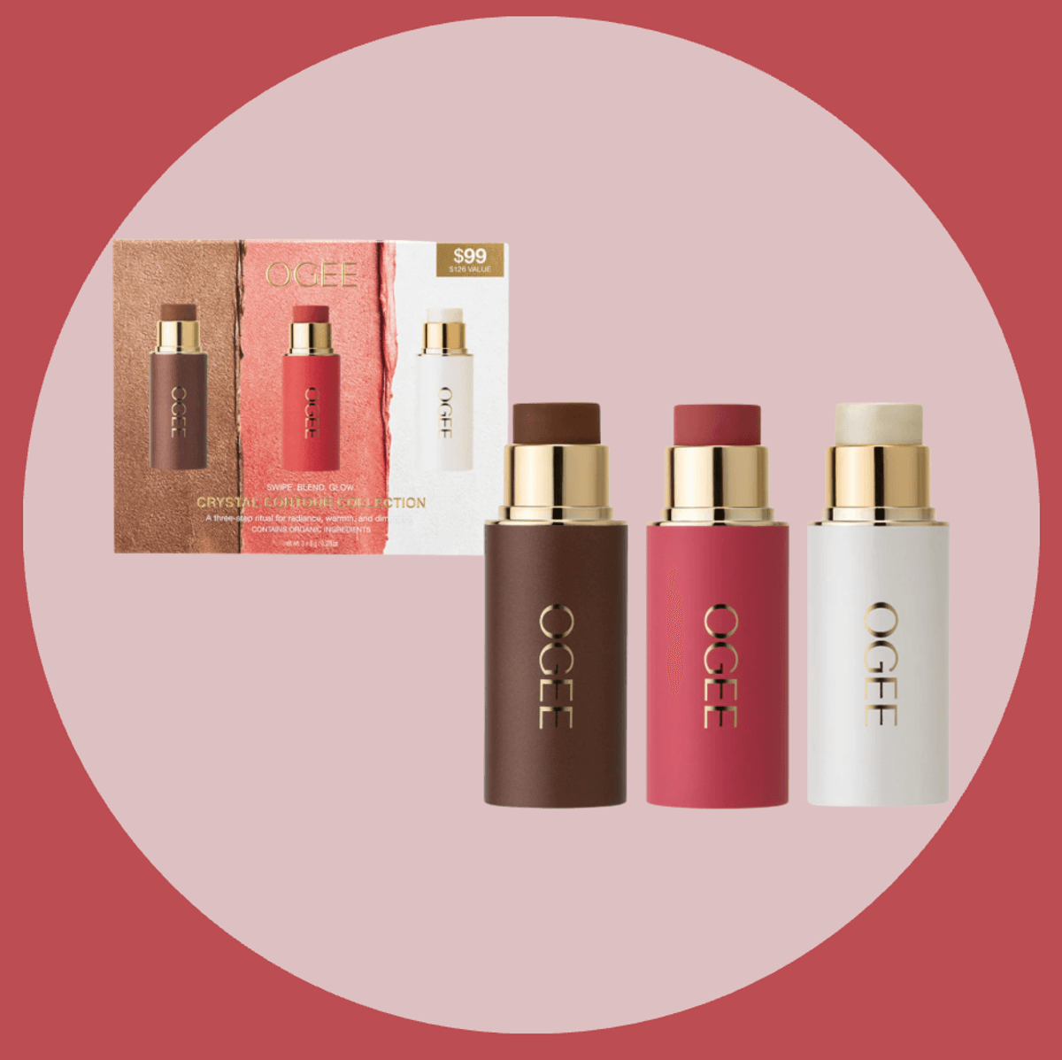 Three Ogee beauty sticks with packaging on a pink circular background.
