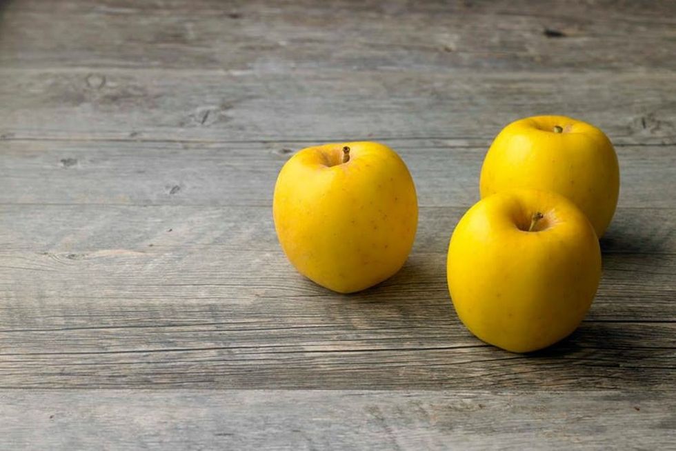 Three Opal Apples on a brown table