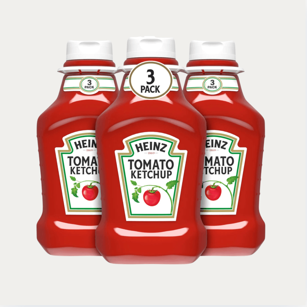 Three-pack of Heinz Tomato Ketchup bottles with a white background.