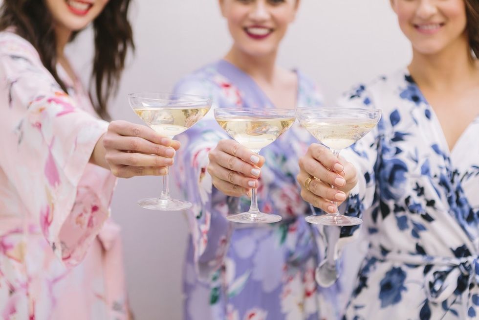 three women cheers-ing champagne