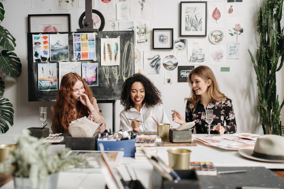 three women painting at a table together what to do after a breakup
