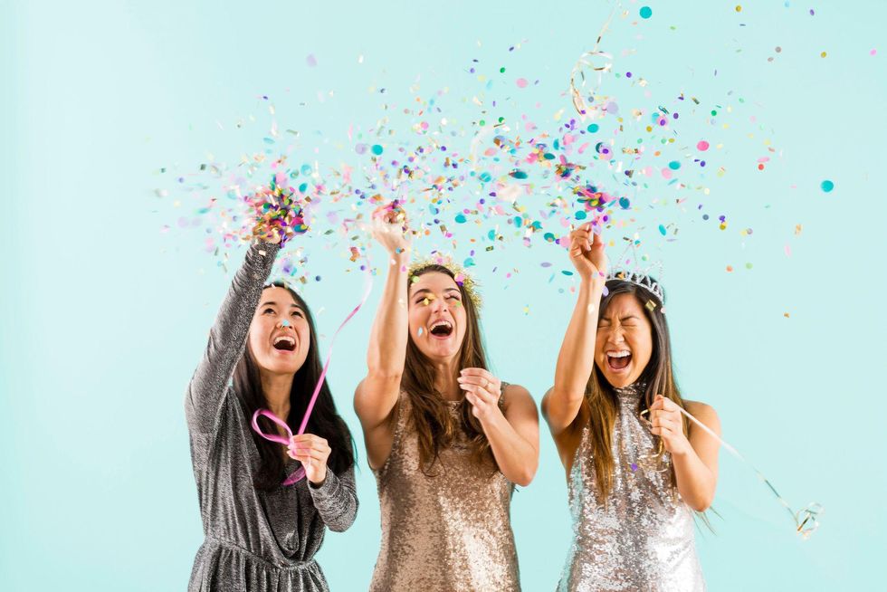 three women throwing confetti