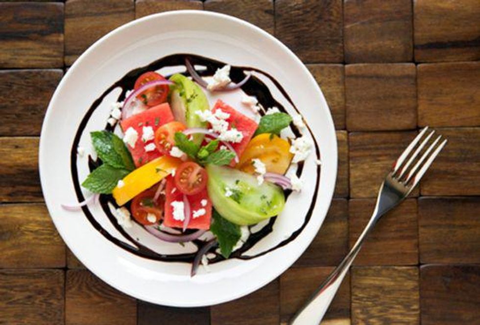 Tomato and Watermelon Salad with balsamic drizzle on a white plate