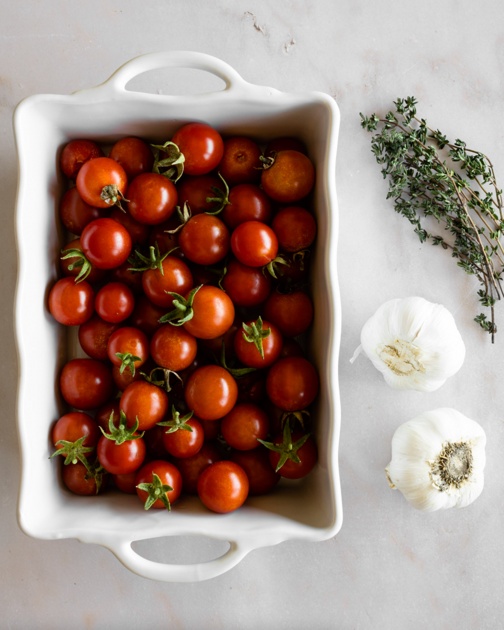 tomatoes in a baking dish with garlic