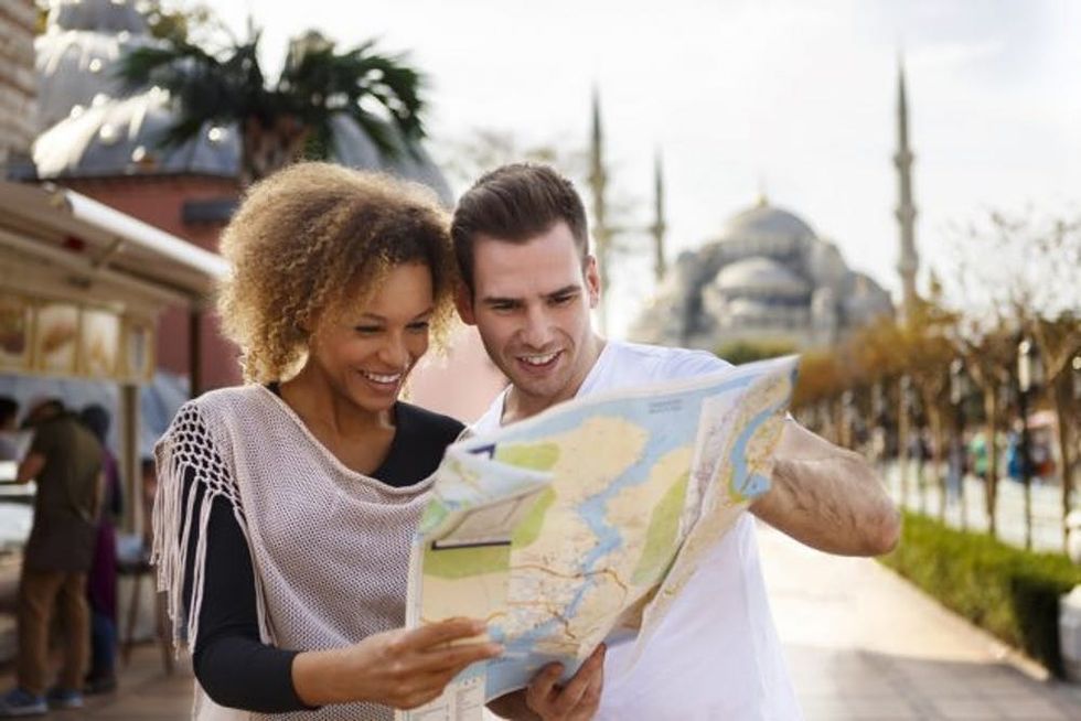 Tourists couple map in front of Blue Mosque in Istanbul Sultanahmet