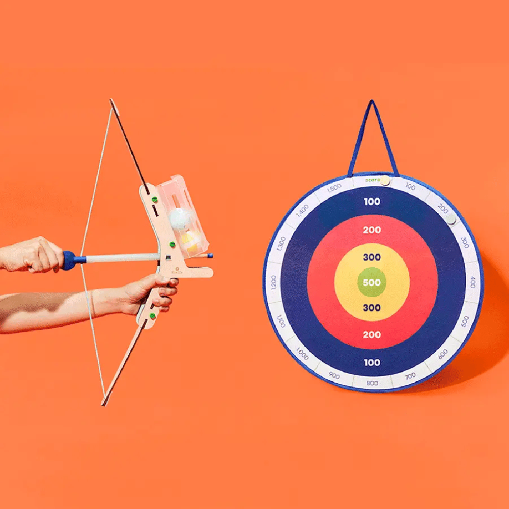 Toy bow and arrow set aiming at a colorful target on an orange background.