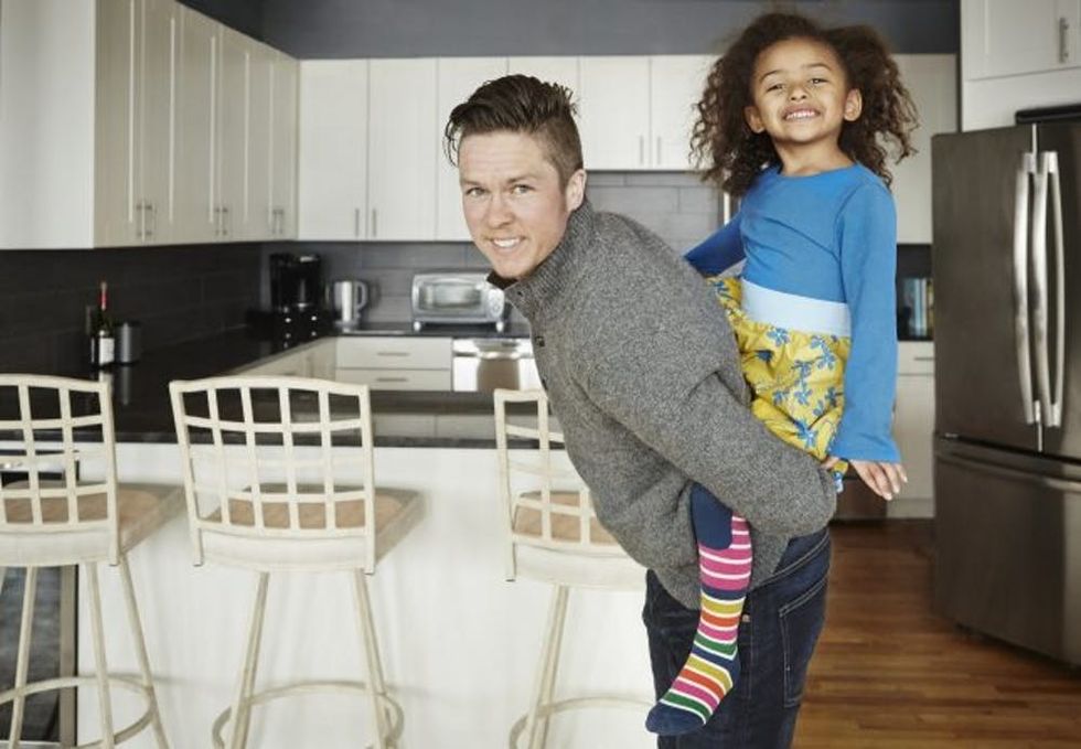 Transgender dad plays with daughter in the kicthen