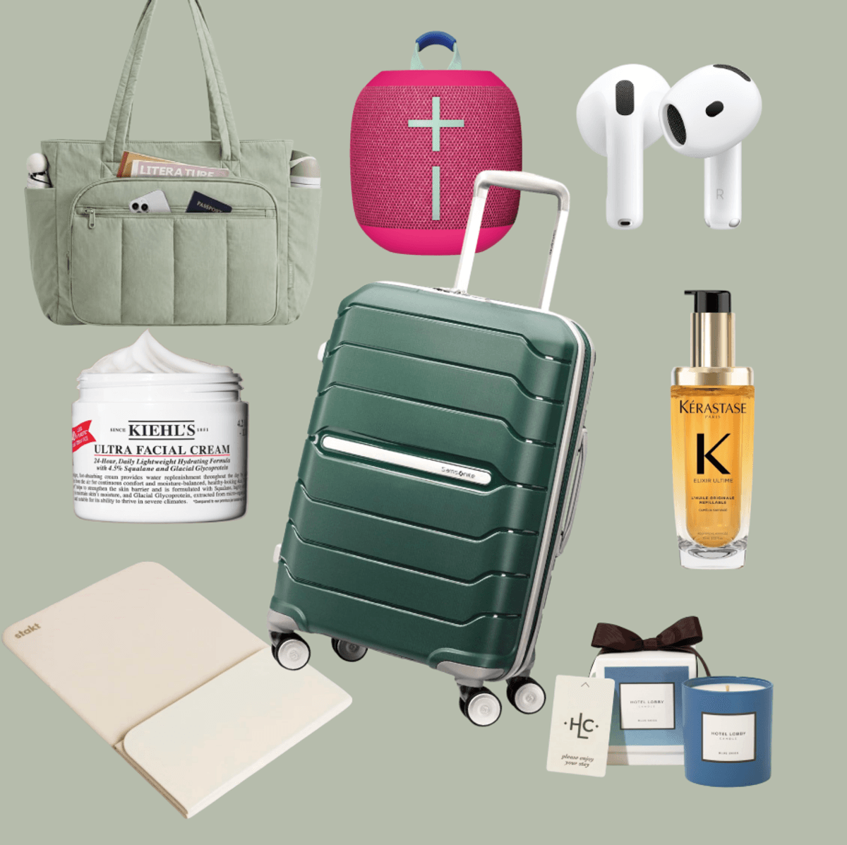 Travel essentials: suitcase, tote, speaker, earbuds, cream, oil, notebook, candle set.