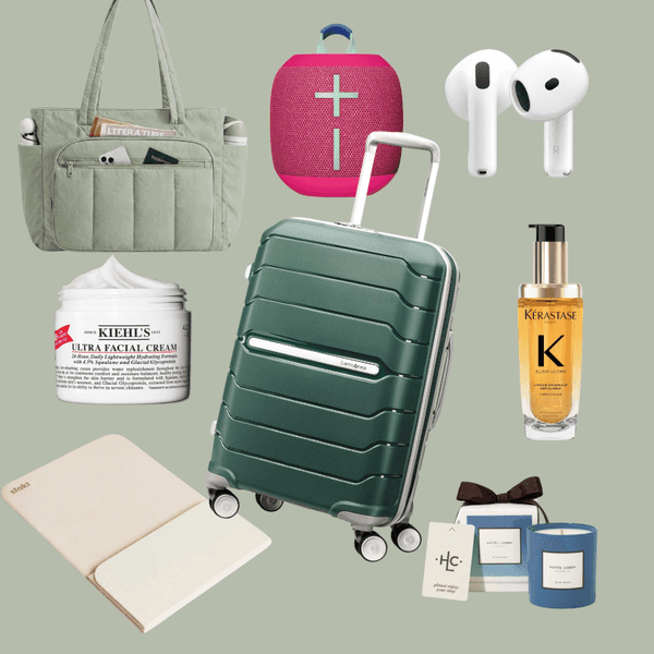 Travel essentials: suitcase, tote, speaker, earbuds, cream, oil, notebook, candle set.