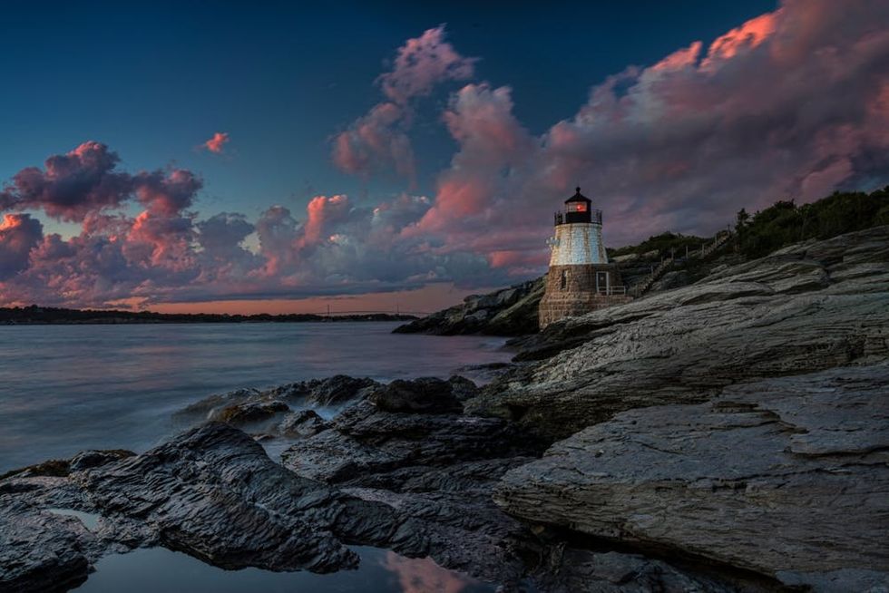 Twilight clouds gather behind a Newport lighthouse