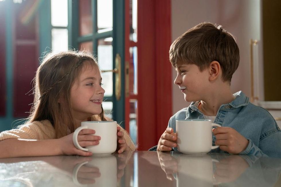 twin boy and girl drinking out of mugs