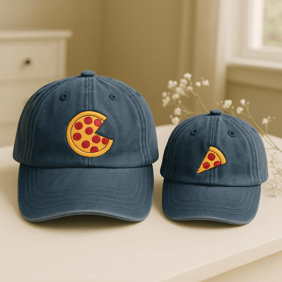 Two blue caps with pizza slice designs on a table.