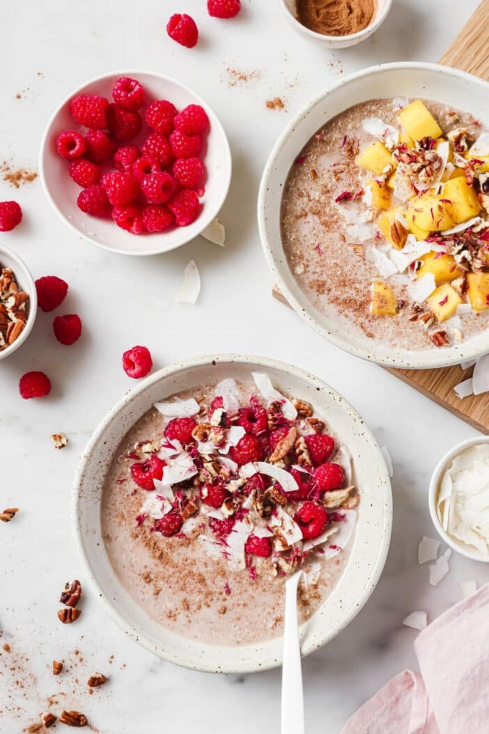 Two bowls of porridge sit on a white countertop.