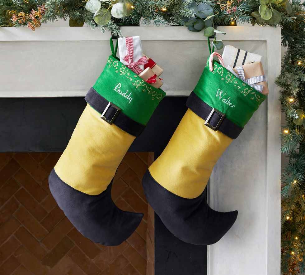 Two Elf stocks hang on top of a fireplace.