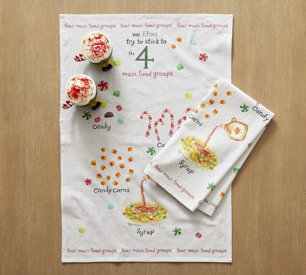 Two Elf tea towels are on a wooden surface.