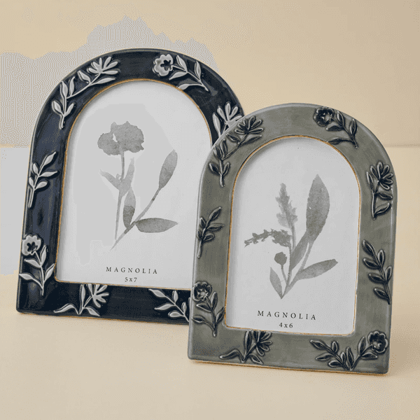 Two floral-engraved picture frames with botanical prints, labeled Magnolia.