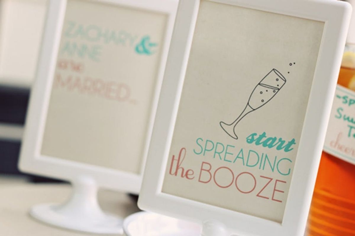 Two framed signs celebrate marriage and drinks with festive text.